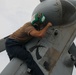 Sailors aboard the USS John Finn conduct routine maintenance on an MH-60R Sea Hawk in the Strait of Malacca