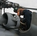 Sailors aboard the USS John Finn conduct routine maintenance on an MH-60R Sea Hawk in the Strait of Malacca