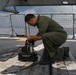 Sailors aboard the USS John Finn conduct routine maintenance on an MH-60R Sea Hawk in the Strait of Malacca
