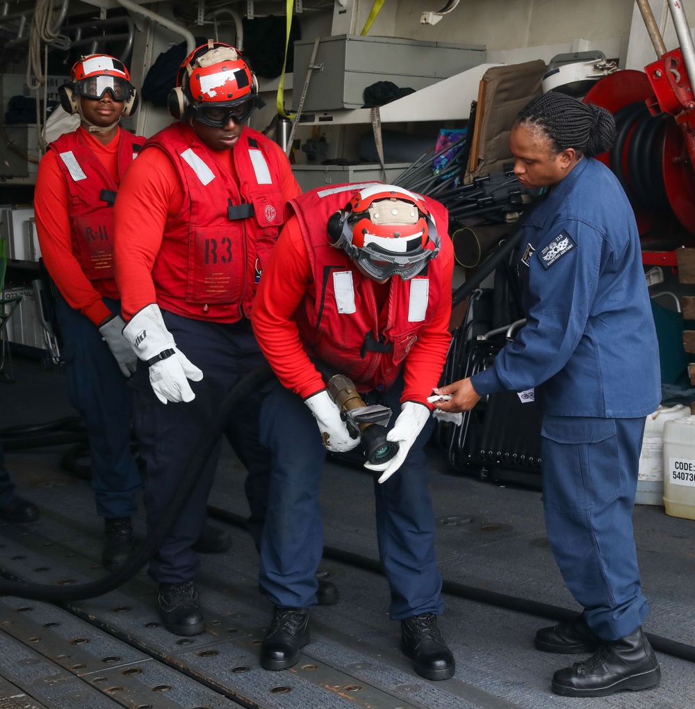 Sailors aboard the USS John Finn conduct a crash and salvage drill in the Indian Ocean