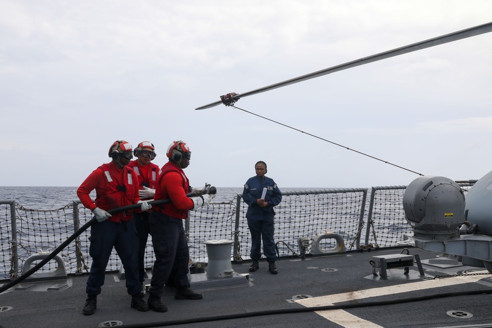 Sailors aboard the USS John Finn conduct a crash and salvage drill in the Indian Ocean