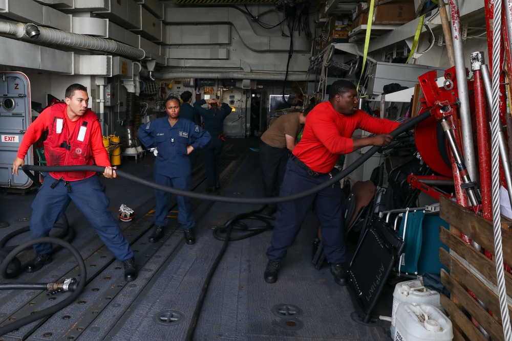 Sailors aboard the USS John Finn conduct a crash and salvage drill in the Indian Ocean