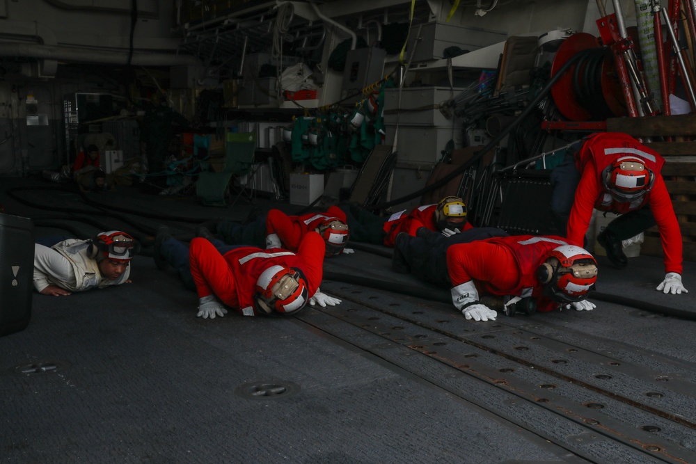 Sailors aboard the USS John Finn conduct a crash and salvage drill in the Indian Ocean