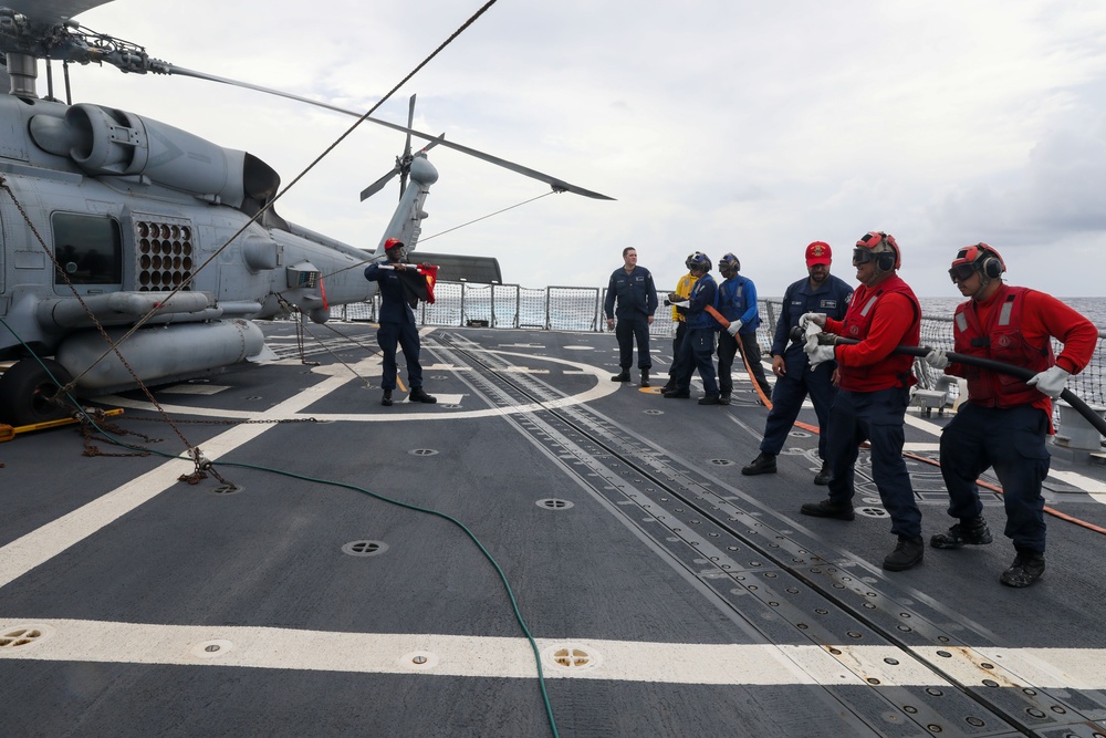Sailors aboard the USS John Finn conduct a crash and salvage drill in the Indian Ocean