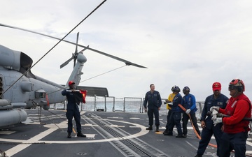 Sailors aboard the USS John Finn conduct a crash and salvage drill in the Indian Ocean