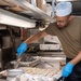 USS PEARL HARBOR (LSD 52) Sailors prepare lunch in the galley