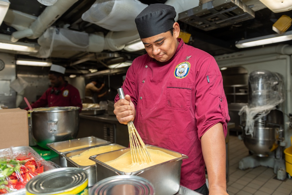 USS PEARL HARBOR (LSD 52) Sailors prepare lunch in the galley
