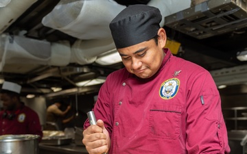 USS PEARL HARBOR (LSD 52) Sailors prepare lunch in the galley
