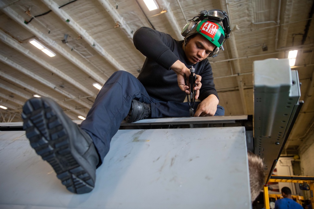 Strike Fighter Squadron 87 Sailor Conducts Maintenance