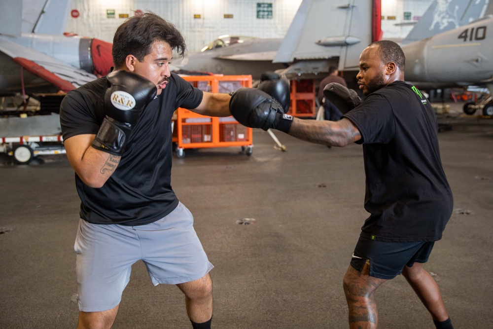USS Gerald R. Ford (CVN 78) Sailors Spar in the Hangar Bay