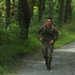 Sgt. Robert Ruiz-Rhoads runs with rucksack in river operations - 2025 National Best Warrior