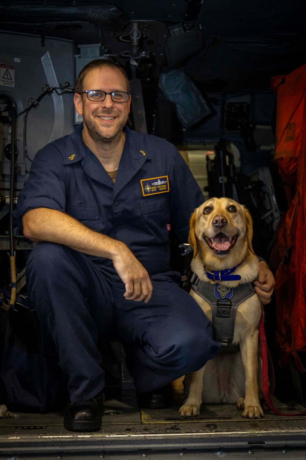 USS Gerald R. Ford (CVN 78) Expeditionary Facility Working Dog Greets Sailors