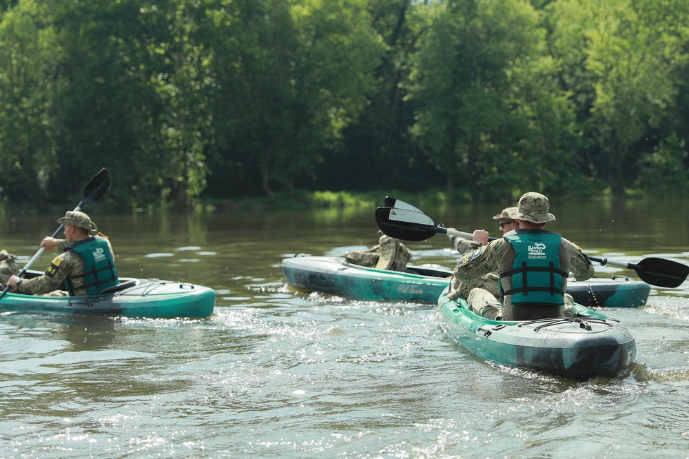 Competitors paddle kayak in River Operations - 2025 National Best Warrior