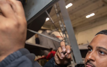 Strike Fighter Squadron 213 Sailor Conducts Maintenance