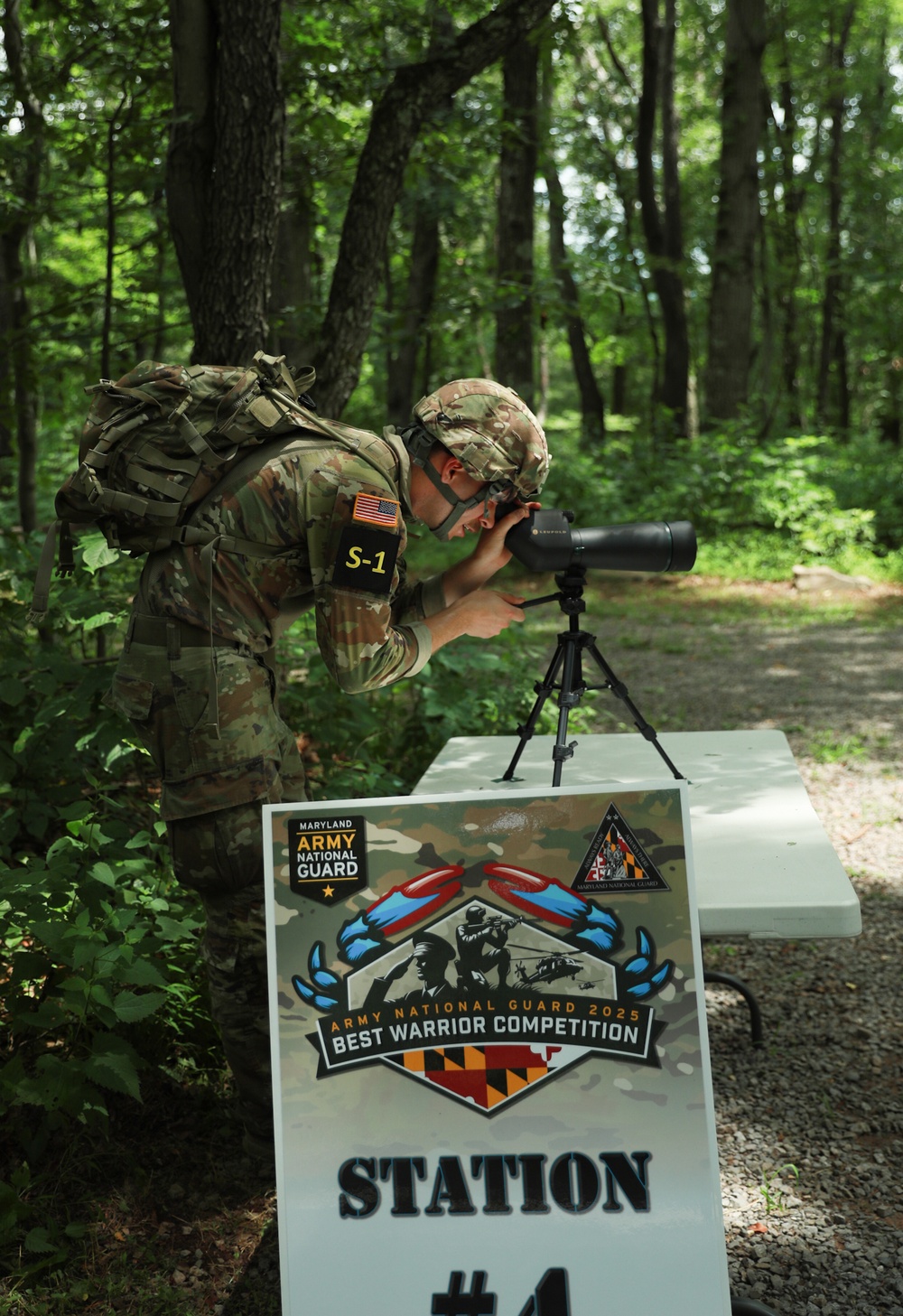 Spc. Adam Andrews focuses spotting scope - 2025 National Best Warrior