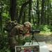 Spc. Adam Andrews focuses spotting scope - 2025 National Best Warrior