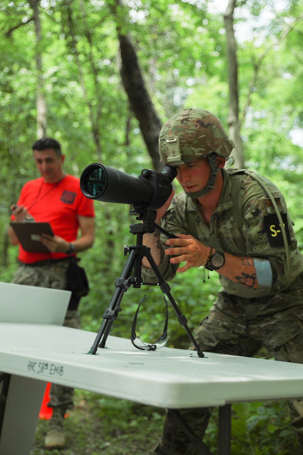 Sgt. Michael Fouts focuses spotting scope - 2025 National Best Warrior