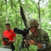 Sgt. Michael Fouts focuses spotting scope - 2025 National Best Warrior