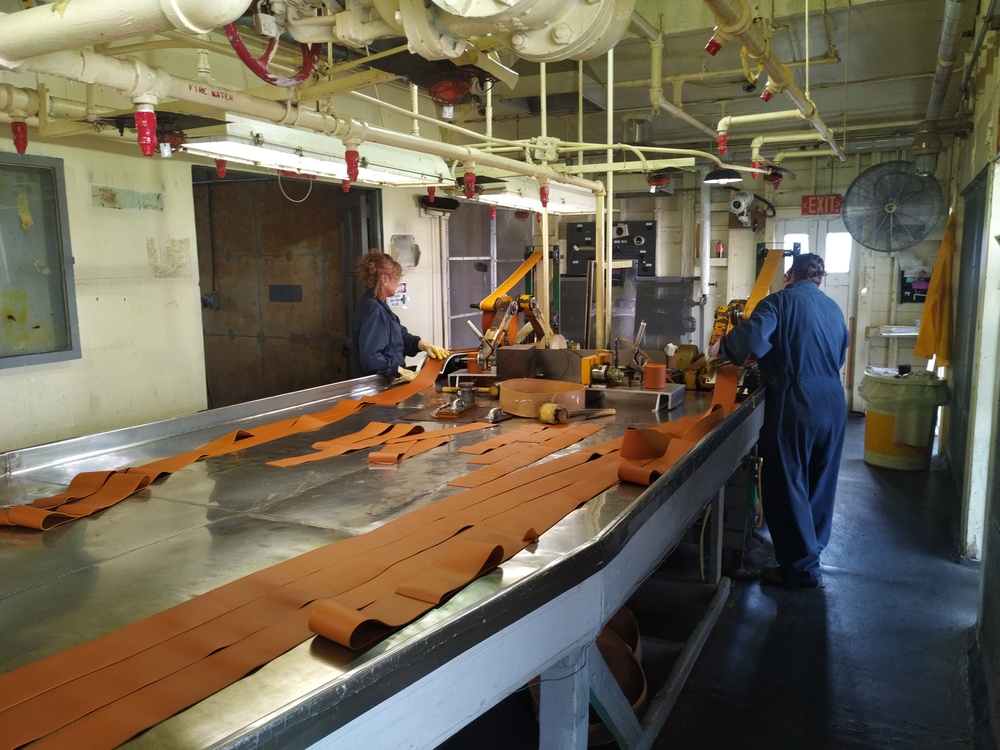 Radford Army Ammunition Plant employee in roll powder line rolling strips of ammunition
