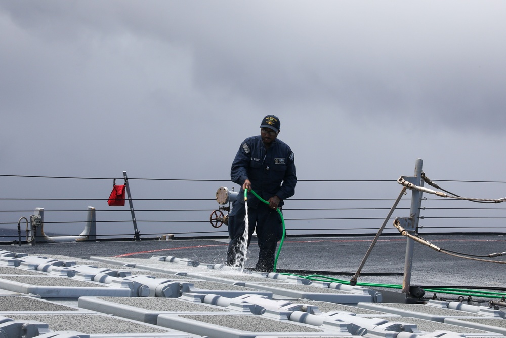Sailors aboard the USS John Finn conduct a freshwater wash down in the Indian Ocean