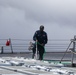 Sailors aboard the USS John Finn conduct a freshwater wash down in the Indian Ocean