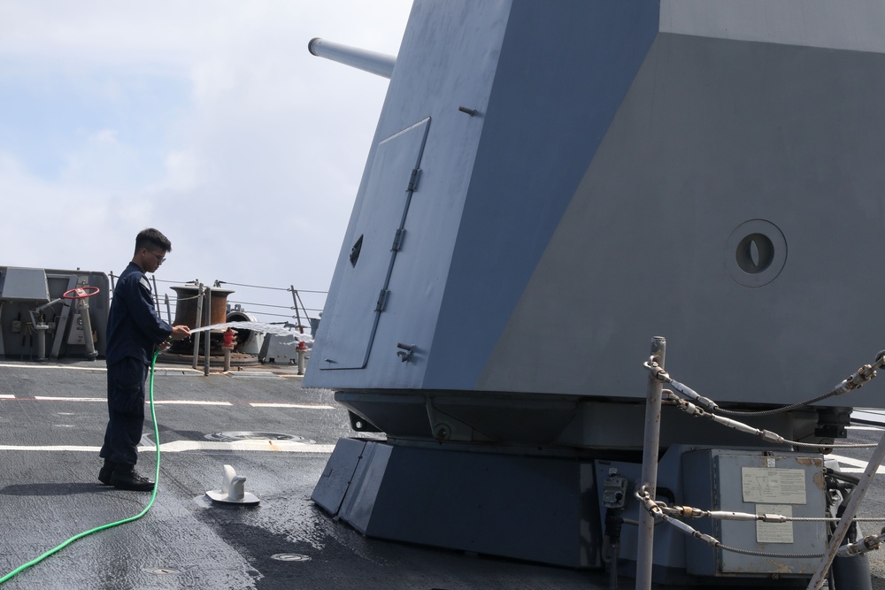 Sailors aboard the USS John Finn conduct a freshwater wash down in the Indian Ocean