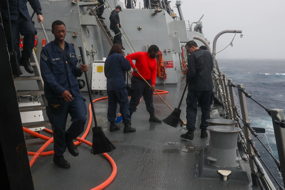 Sailors aboard the USS John Finn conduct a freshwater wash down in the Indian Ocean