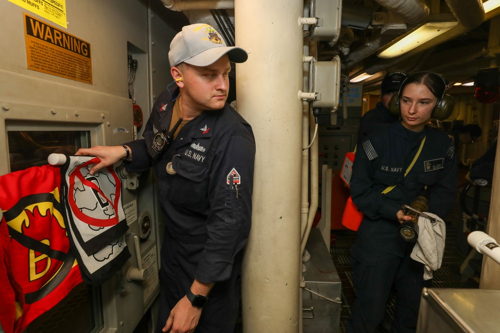 Sailors aboard the USS John Finn conduct an engineering team training drill in the Indian Ocean