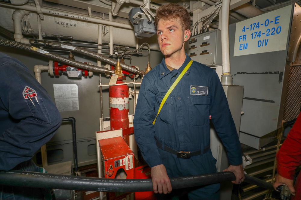 Sailors aboard the USS John Finn conduct an engineering training team drill in the Indian Ocean