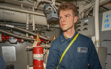 Sailors aboard the USS John Finn conduct an engineering training team drill in the Indian Ocean