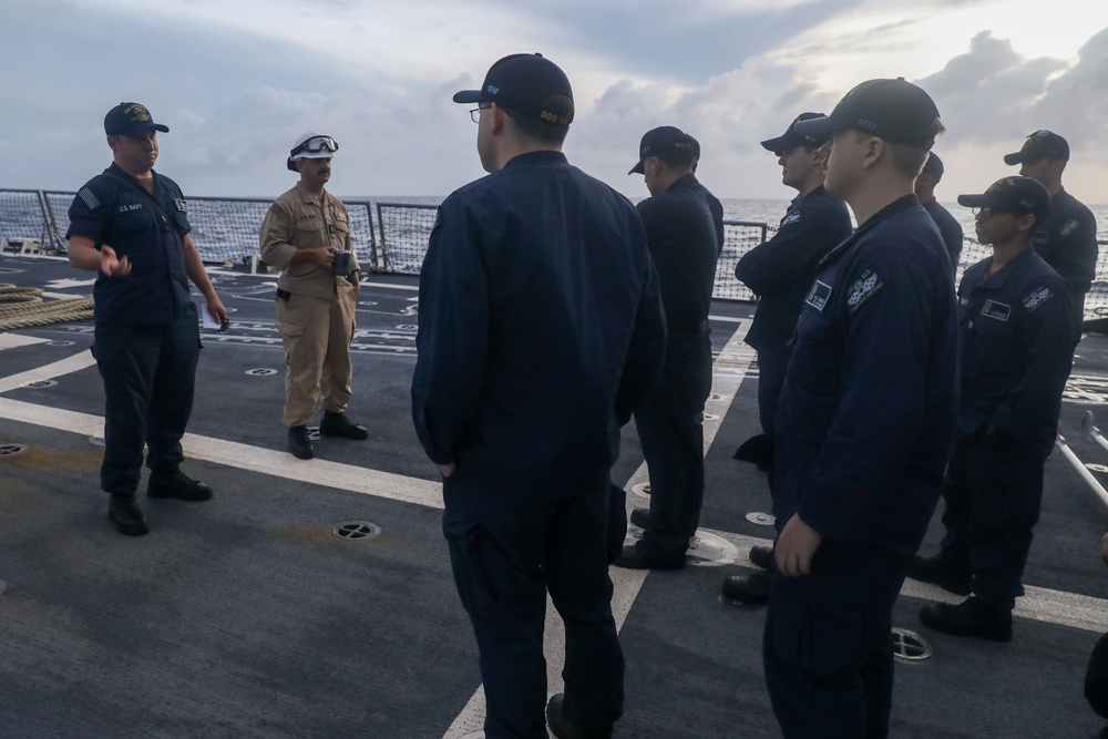Sailors aboard the USS John Finn conduct a sea and anchor detail in Diego Garcia