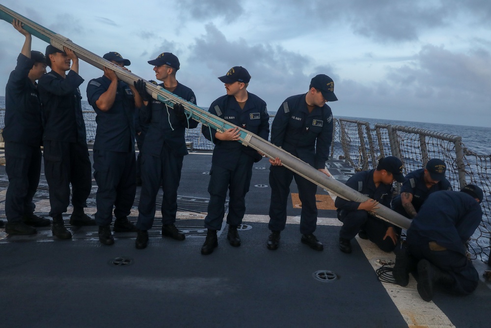 Sailors aboard the USS John Finn conduct a sea and anchor detail in Diego Garcia