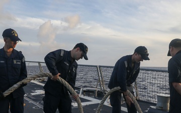 Sailors aboard the USS John Finn conduct a sea and anchor detail in Diego Garcia