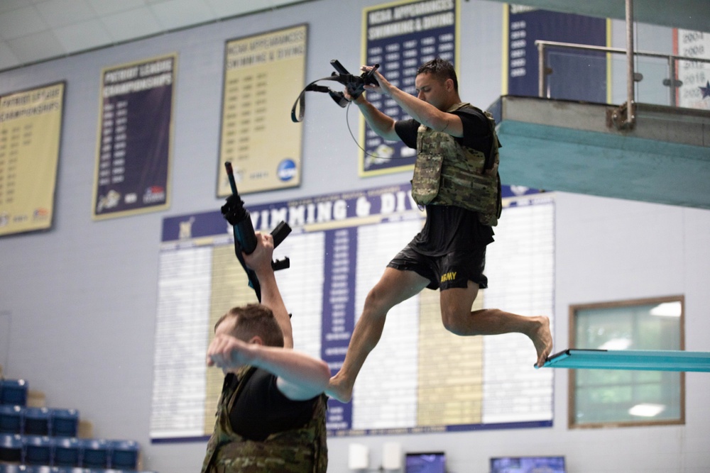 Spc. Robert Ruiz-Rhoades jumps off a diving board - 2025 National Best Warrior