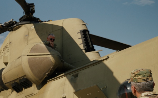 Command Sgt. Maj. Jasen Pask, speaks with a 1-111th Aviation Regiment UH-47 Chinook crewmember at their arrival at Fort Irwin