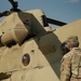 Command Sgt. Maj. Jasen Pask, speaks with a 1-111th Aviation Regiment UH-47 Chinook crewmember at their arrival at Fort Irwin