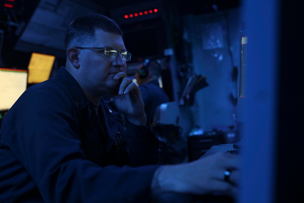 USS Forrest Sherman (DDG 98) Sailors stand watch in CIC.