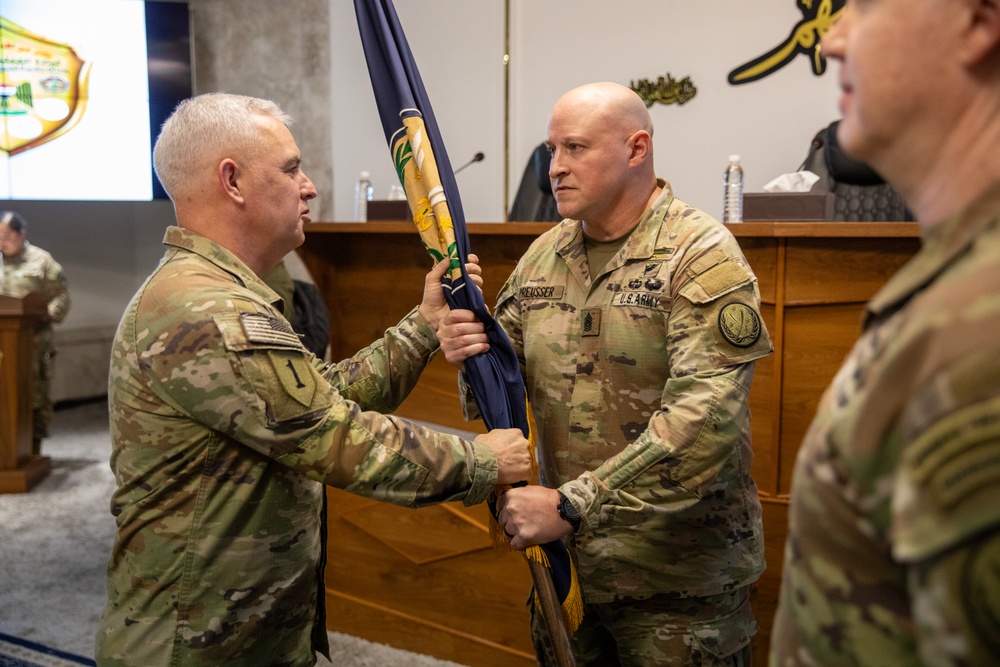 Brig. Gen. Lambert Hands CJTF-OIR Colors to Command Sgt. Maj. Preusser During Change of Command Ceremony