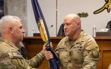 Brig. Gen. Lambert Hands CJTF-OIR Colors to Command Sgt. Maj. Preusser During Change of Command Ceremony
