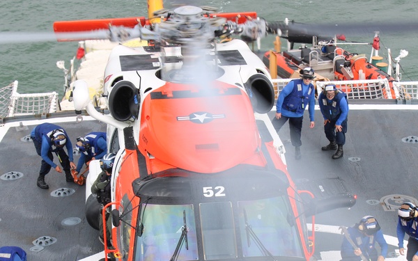 Coast Guard Cutter Escanaba and Air Station Elizabeth City crew members conduct helicopter-ship qualification training in the Chesapeake Bay