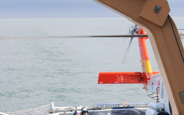 Coast Guard Cutter Escanaba and Air Station Elizabeth City crew members conduct helicopter-ship qualification training in the Chesapeake Bay