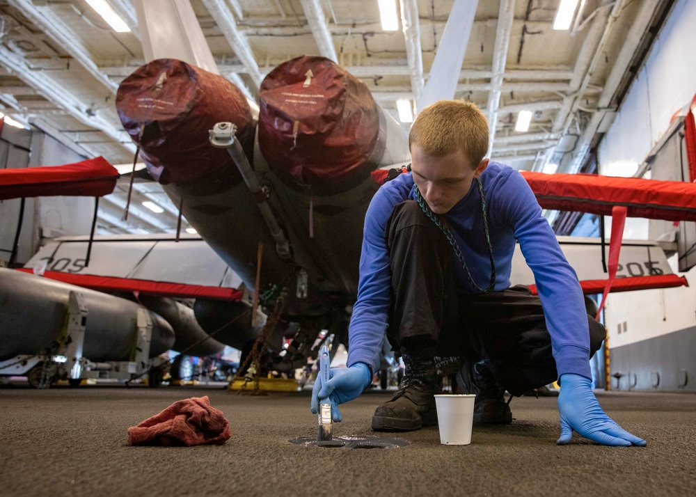 USS Gerald R. Ford (CVN 78) Sailor Paints A Padeye