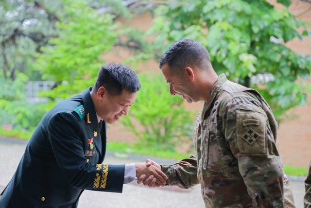 Respect and Recognition: Allies in Arms Share a Moment of Honor