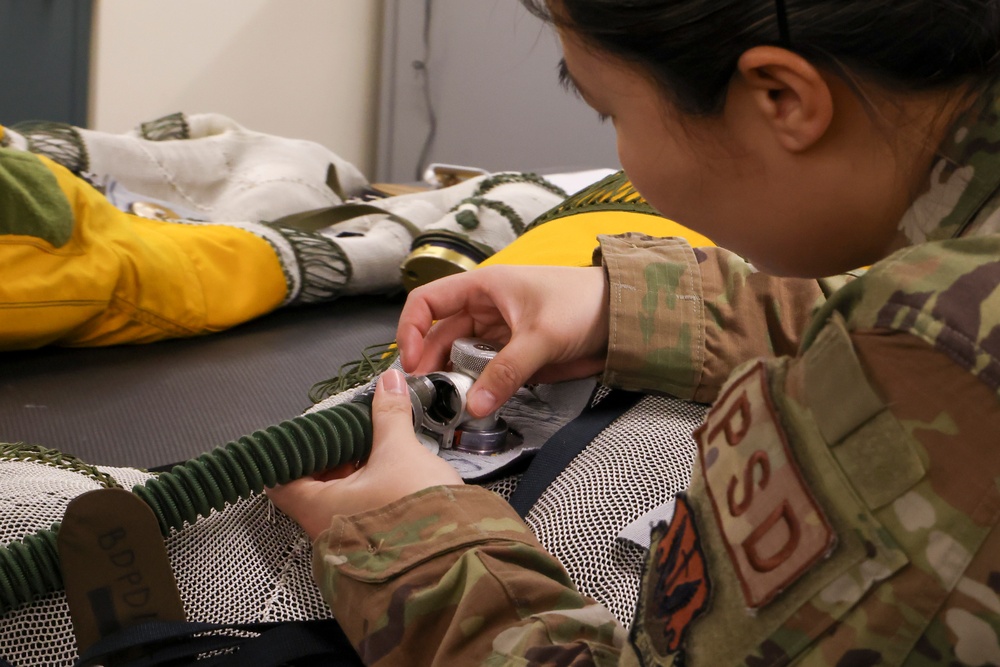 9th PSPTS inspects aircraft vent hose for U-2 high altitude pressure suit