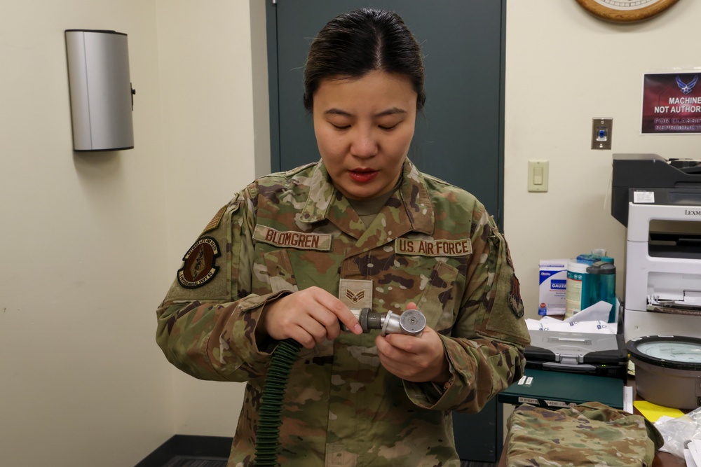 9th PSPTS inspects aircraft vent hose for U-2 high altitude pressure suit