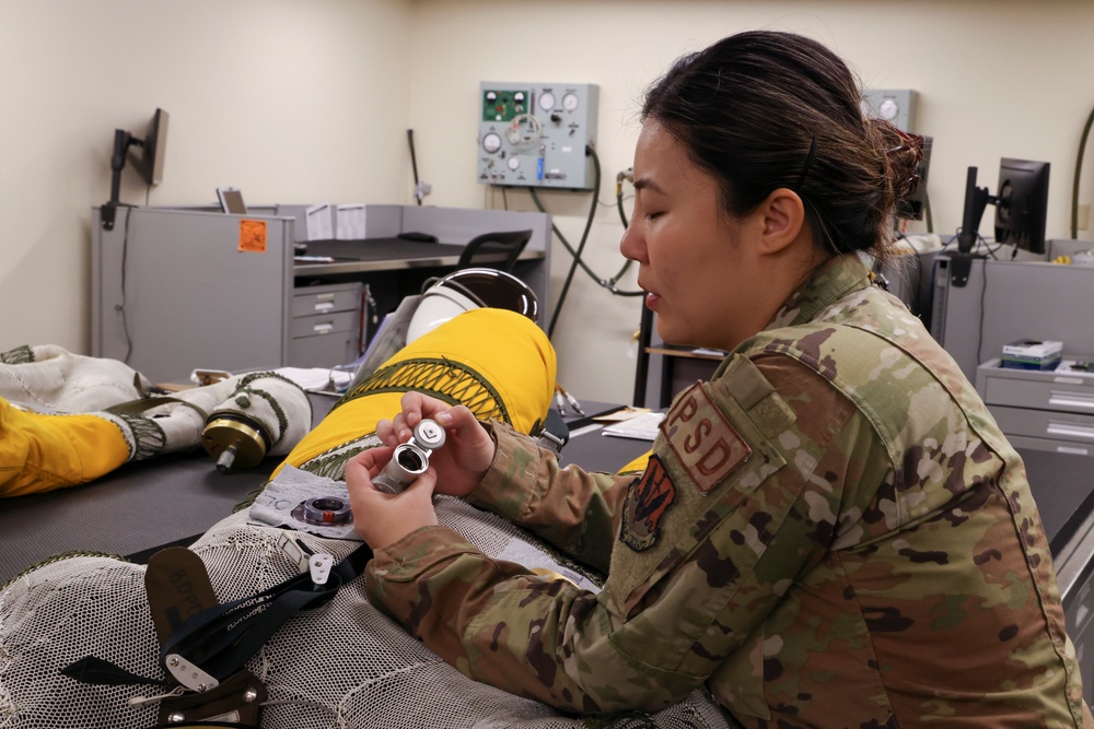 9th PSPTS inspects aircraft vent hose for U-2 high altitude pressure suit
