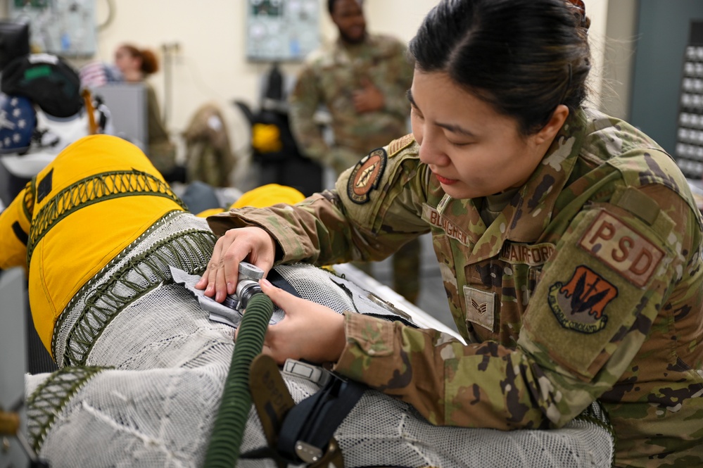 9th PSPTS inspects aircraft vent hose for U-2 high altitude pressure suit
