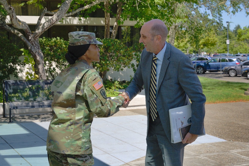 Madigan Commander, U.S. Army Col. Hope M. Williamson-Younce greets Dr. Stephen Ferrara, acting assistant secretary of defense for Health Affairs, at Madigan Army Medical Center