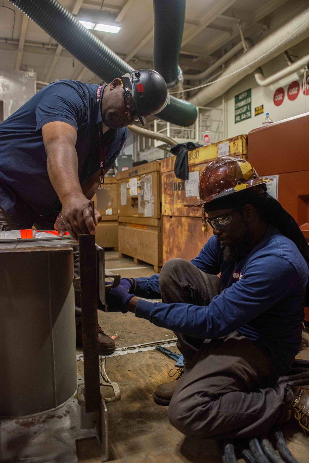 Contractors perform maintenance aboard USS Ronald Reagan