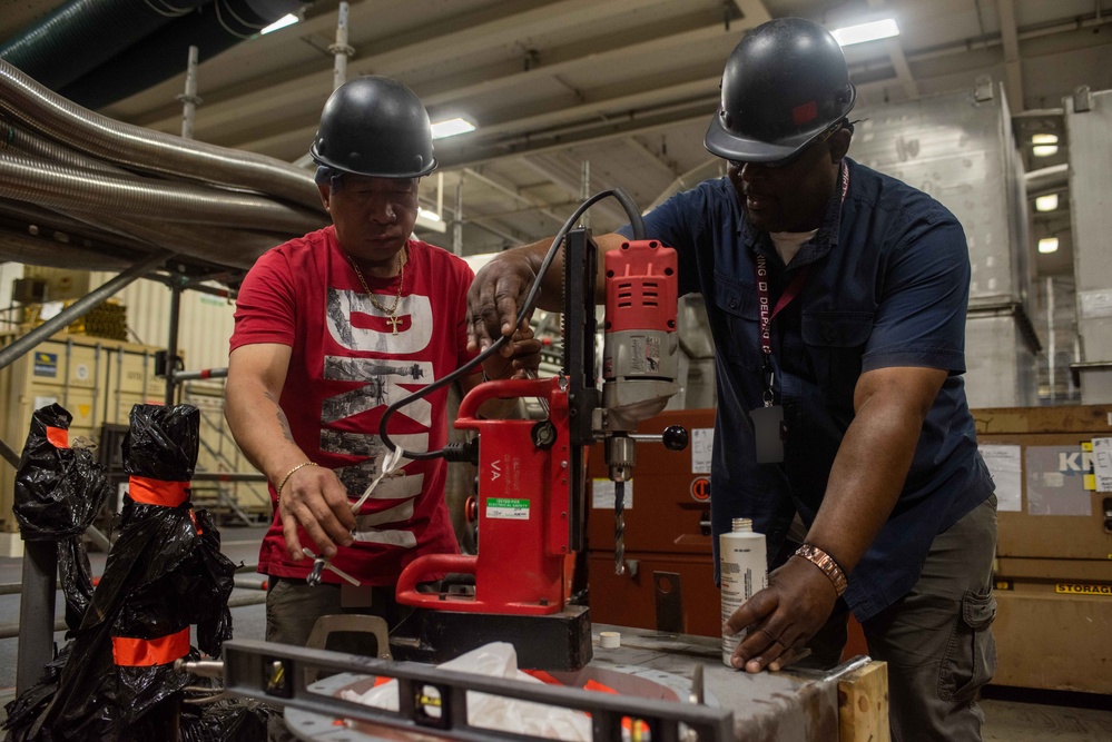 Contractors perform maintenance aboard USS Ronald Reagan